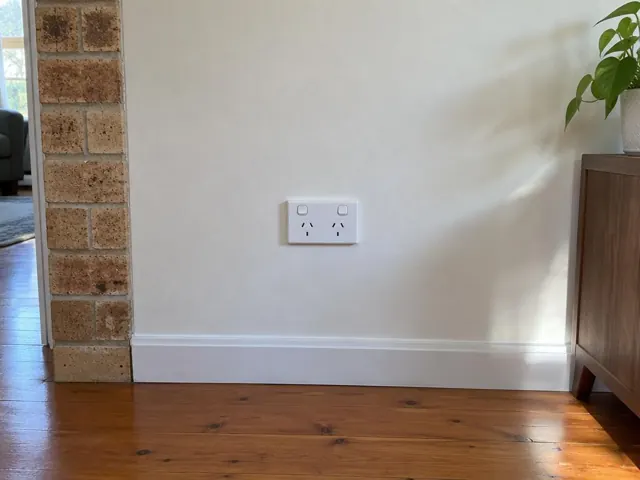 White double power point on a painted wall above a timber floor and skirting in Tenambit